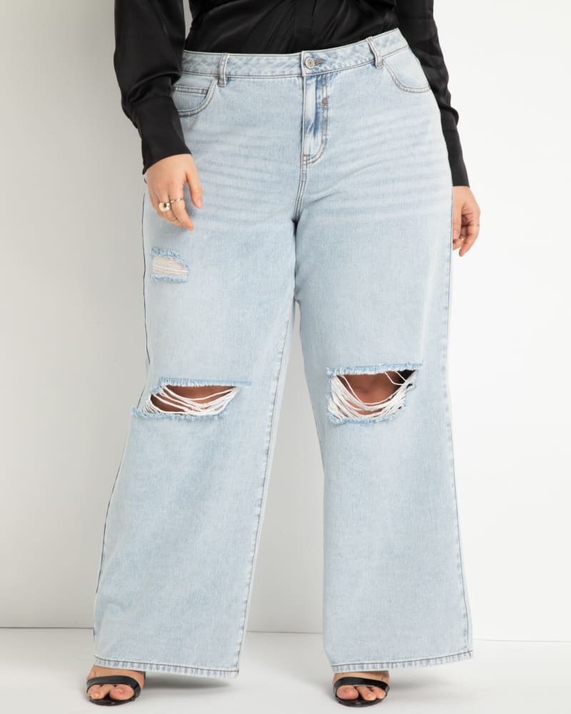 Front of a model wearing a size 22 Wide Leg Distressed Jeans- Light Wash in Light Wash by ELOQUII. | dia_product_style_image_id:271006